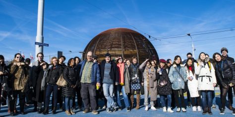 Ma Art and Science students, tutors and members from CERN standing for a photograph together with a bright blue sky backdrop.