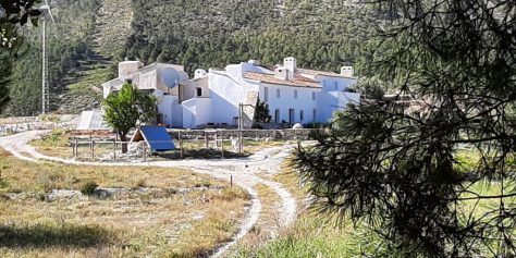 image of a landscape with a series of white houses and a path meandering around the houses