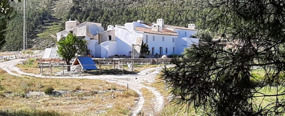 image of a landscape with a series of white houses and a path meandering around the houses