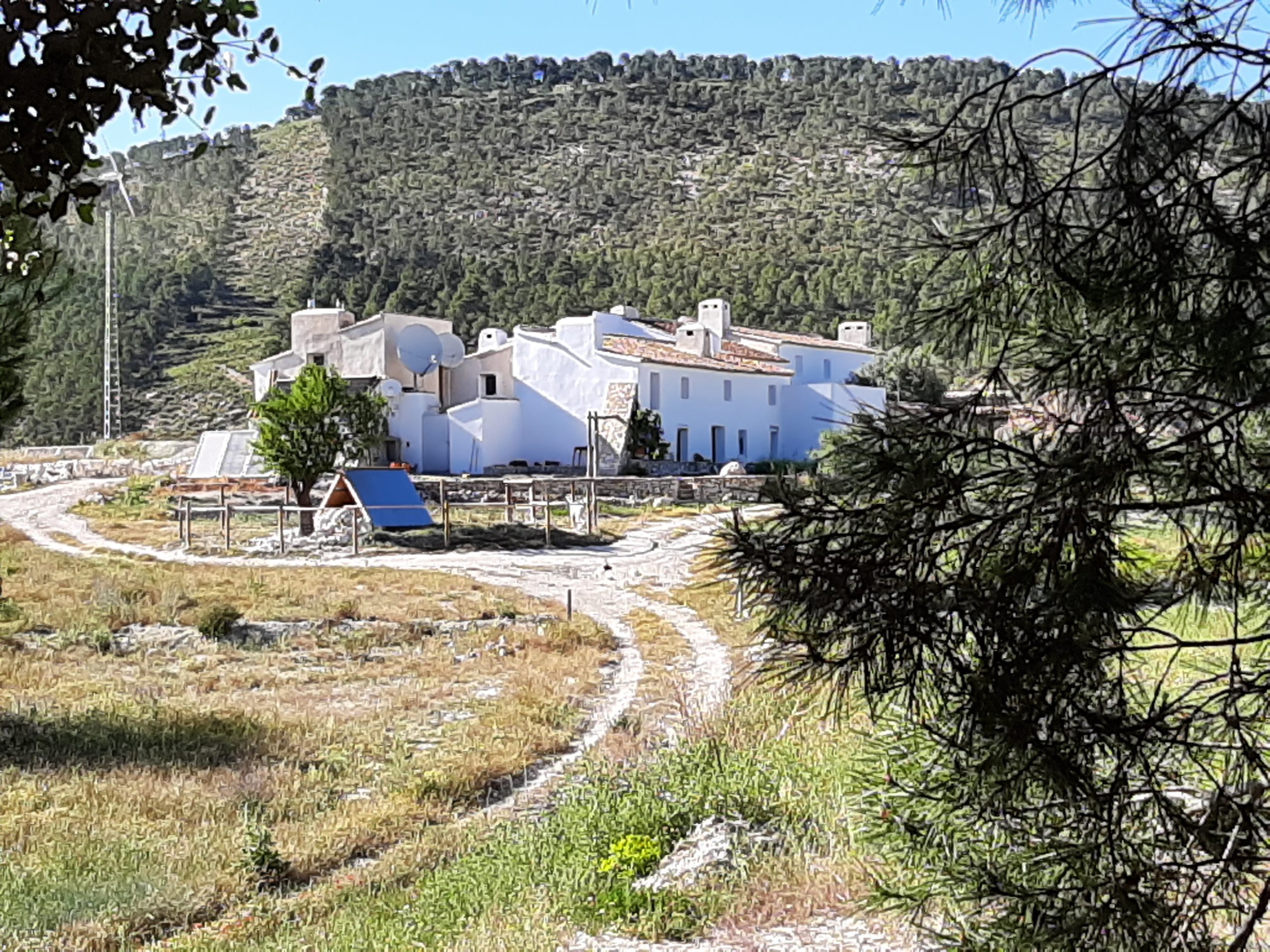 image of a landscape with a series of white houses and a path meandering around the houses