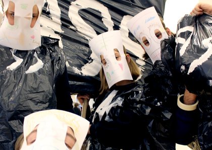 Image of several students with white masks on and posing in front of the camera