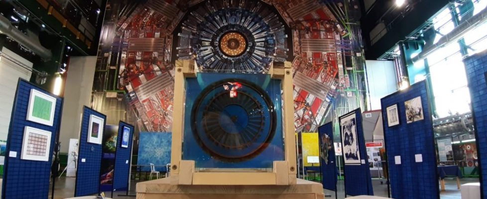 Various artworks against a backdrop of a giant machinery.