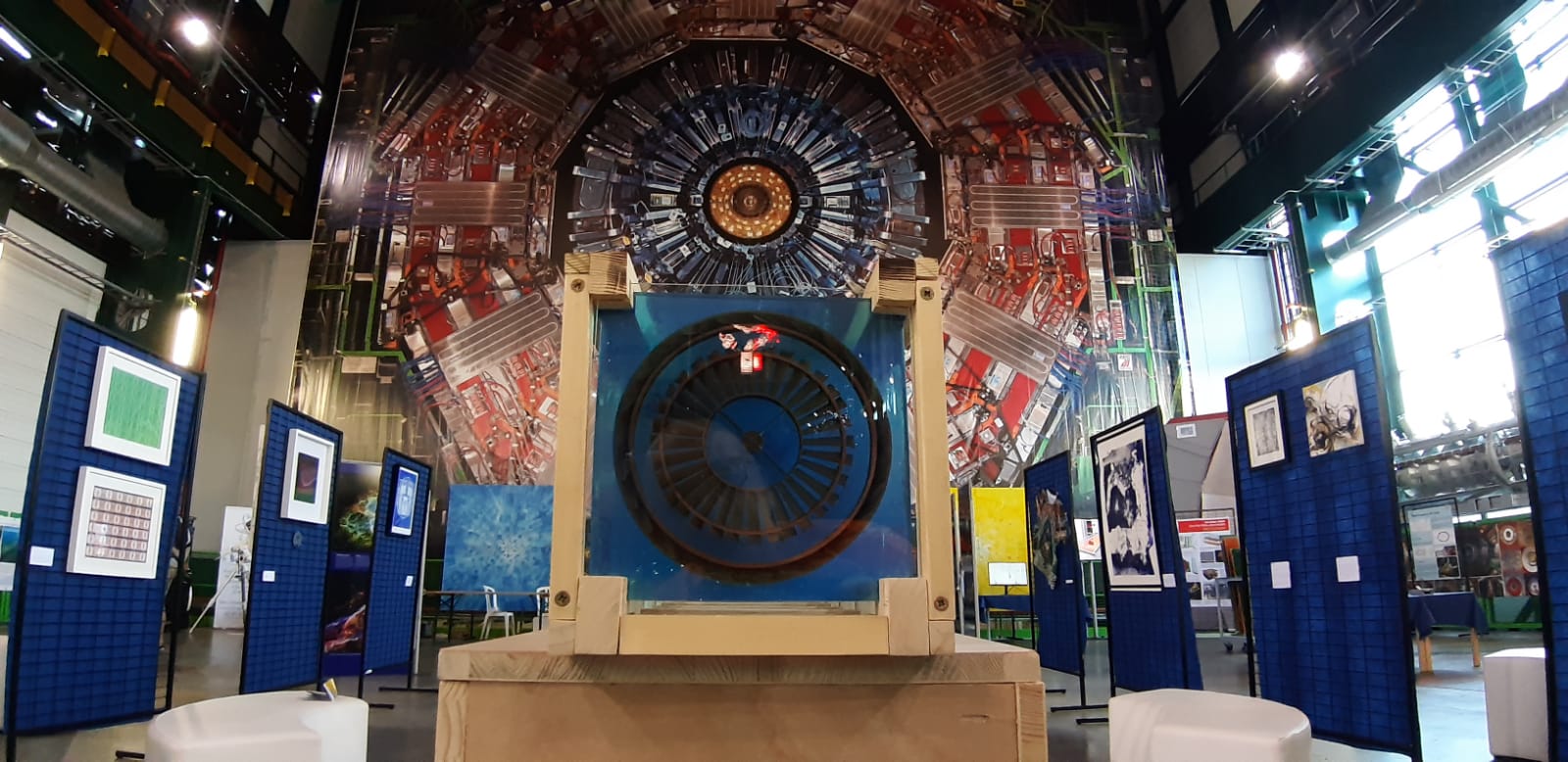 Various artworks against a backdrop of a giant machinery.